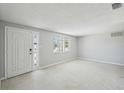 Bright living room featuring a neutral color scheme, plenty of natural light, and ample space at 1153 Honor Dr, Holiday, FL 34690