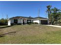 Beautiful one story home with a spacious lawn, featuring a modern two car garage and neutral color palette at 12021 Coleman Ave, Port Charlotte, FL 33981