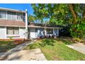 Inviting townhome featuring manicured landscaping and a welcoming entrance at 1236 Abbey Crescent Ln, Clearwater, FL 33759