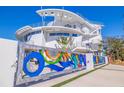 Stunning modern home with a colorful art gate, clean lines, and eye-catching architectural details at 12650 7Th E St, Treasure Island, FL 33706