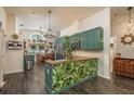 Bright kitchen with a breakfast bar, stylish backsplash, modern appliances, and a dining area at 15856 49Th N St, Clearwater, FL 33762