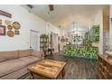 Open-concept living room with stylish tile floors and eclectic decor leading to the colorful kitchen at 15856 49Th N St, Clearwater, FL 33762