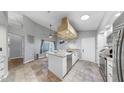 Bright kitchen with granite countertops, stainless steel appliances, tile floor, and island at 1613 E Del Webb Blvd, Sun City Center, FL 33573