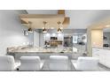 Modern kitchen featuring granite countertops, stainless steel appliances, pendant lighting, and ample counter space at 1613 E Del Webb Blvd, Sun City Center, FL 33573