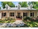 Charming front porch featuring a stone walkway, well-maintained landscaping, and classic architectural details at 16420 Iola Woods Trl, Dade City, FL 33523