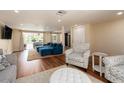 Open floor plan living room with wood floors, an accent chair, and a large blue sectional sofa at 1650 Springdale Dr, Holiday, FL 34691