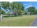 Expansive lawn with mature trees shading a beautiful single-Gathering home at 1806 Chickasaw Trl, Valrico, FL 33596