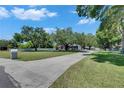 Long driveway leading to a charming home with a lush green lawn at 1806 Chickasaw Trl, Valrico, FL 33596