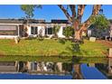 Home's back patio overlooking the tranquil canal at 200 Portree Dr, Dunedin, FL 34698