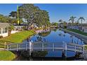 Scenic view of a canal, surrounded by well-maintained landscaping and homes at 200 Portree Dr, Dunedin, FL 34698