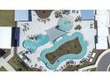 Aerial view of community pools, sun shades, and lounging areas with many chairs at 31966 Asbury Ave, Wesley Chapel, FL 33545