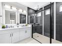 Modern bathroom with dual vanity, backlit mirrors, and a sleek black-framed shower at 31966 Asbury Ave, Wesley Chapel, FL 33545