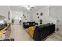 Open-concept living room with tile flooring and modern décor at 36519 Garden Wall Way, Zephyrhills, FL 33541