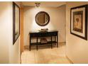 Elegant foyer featuring a console table with decor, a round mirror, and framed artwork at 36750 Us 19 N # 3-124, Palm Harbor, FL 34684
