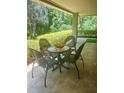 Covered patio with table and chairs overlooking lush green landscaping, perfect for enjoying the outdoors at 36750 Us 19 N # 3-124, Palm Harbor, FL 34684