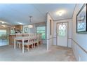 Inviting dining area features a large table with seating for eight, adjacent to kitchen at 4041 Lane Rd, Zephyrhills, FL 33541