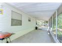 Spacious screened-in porch, perfect for relaxing and enjoying the outdoors, with a grill at 4041 Lane Rd, Zephyrhills, FL 33541