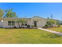 Charming single-story home with lush lawn, landscaped yard, and inviting pathway at 5298 Oxford N Ave, St Petersburg, FL 33710