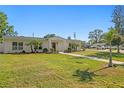 Charming single-story home with lush lawn, landscaped yard, and inviting pathway at 5298 Oxford N Ave, St Petersburg, FL 33710