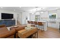 Open-concept living space featuring a modern kitchen with a large island and stylish seating at 5298 Oxford N Ave, St Petersburg, FL 33710