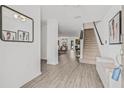 Bright entryway featuring wood floors, stairs, and views of the dining and living areas, for a seamless transition at 5429 Companion Ln, Tampa, FL 33619
