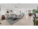 Open-concept living room with modern furniture, flowing into dining area and kitchen, perfect for entertaining at 5429 Companion Ln, Tampa, FL 33619