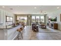 Open-concept living and dining area featuring stylish decor, a large TV, and ample natural light at 6753 Flint Creek Dr, Land O Lakes, FL 34638