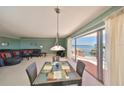 Bright open living room with a dining area, balcony access, and beautiful ocean views at 7430 Sunshine Skyway S Ln # 403, St Petersburg, FL 33711