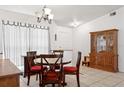 Cozy dining room with classic wooden furniture, including a round table with red cushions and a hutch at 747 Stillview Cir, Brandon, FL 33510