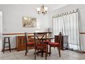 Bright dining area features a wooden table, comfortable seating, and elegant decor with tiled flooring at 747 Stillview Cir, Brandon, FL 33510