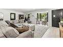 Bright, modern living room with large windows and comfortable seating area at 8721 N Whittier St, Tampa, FL 33617