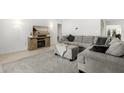 Comfortable living room featuring a cozy sectional sofa and entertainment center at 8721 N Whittier St, Tampa, FL 33617