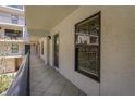 Exterior hallway leading to unit with view of the building's architecture and exterior at 105 4Th Ne Ave # 220, St Petersburg, FL 33701