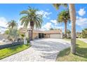 Lovely single Gathering home with a large driveway, attached garage, and stunning landscaping at 15528 Allmand Dr, Hudson, FL 34667