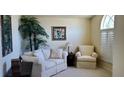 Comfortable sitting area with neutral tones, plush seating, and natural light at 18412 Oriole St, Lutz, FL 33558