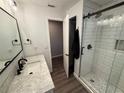 Stylish bathroom featuring a sleek vanity, marble countertop, and a glass-enclosed shower with modern fixtures and design at 1894 Union St, Clearwater, FL 33763