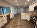 Bright kitchen features white cabinets, granite countertops, and stainless steel appliances at 1894 Union St, Clearwater, FL 33763