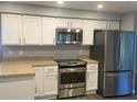 This kitchen features stainless steel appliances, bright cabinets, and ample counter space for cooking at 1894 Union St, Clearwater, FL 33763