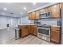 Well-equipped kitchen with stainless steel appliances and brown cabinets, complemented by modern flooring and ample counter space at 1894 Union St, Clearwater, FL 33763