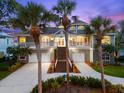 Elegant two-story home featuring a welcoming staircase, double garage, and lush tropical landscaping at 2081 Pointe Alexis Dr, Tarpon Springs, FL 34689