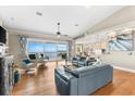 Elegant living room featuring comfortable seating, blue patterned curtains, and a beautiful view of the water at 2081 Pointe Alexis Dr, Tarpon Springs, FL 34689