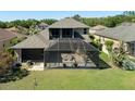 Aerial view of the home's backyard and screened in porch at 27318 Sora Blvd, Wesley Chapel, FL 33544