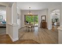 Bright dining room with a chandelier, hardwood floors, and sliding glass doors at 27318 Sora Blvd, Wesley Chapel, FL 33544