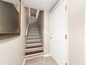 Inviting entryway with hardwood floors, staircase, and a modern front door leading to the main living area at 320 Island Way # 606, Clearwater Beach, FL 33767