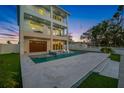 Captivating backyard featuring a sleek pool and stone patio, perfect for outdoor relaxation and entertainment at 326 129Th E Ave, Madeira Beach, FL 33708