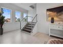 Bright, modern staircase with wood treads, white risers, stainless steel cable railing, and abundant natural light at 326 129Th E Ave, Madeira Beach, FL 33708