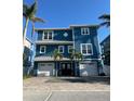Beautiful blue two-story home with a double garage, well-maintained landscaping, and a welcoming entrance at 460 137Th Avenue Cir, Madeira Beach, FL 33708