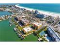 Stunning aerial view of beachfront condos, a pristine beach, and the Gulf of Mexico at 5353 Gulf Blvd # B103, St Pete Beach, FL 33706
