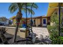 Charming porch with a brick floor, seating, and decorative plants at 5931 33 N Ave, St Petersburg, FL 33710