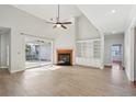 Bright living room featuring vaulted ceilings, a fireplace, and access to outdoor patio at 6518 Paw Pl, Land O Lakes, FL 34639